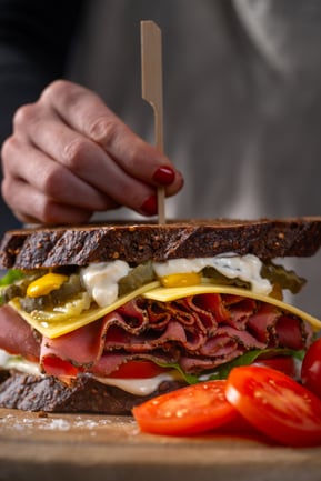New York Style Deli Sandwich_portrait_Hero+hand_side on 1_HR